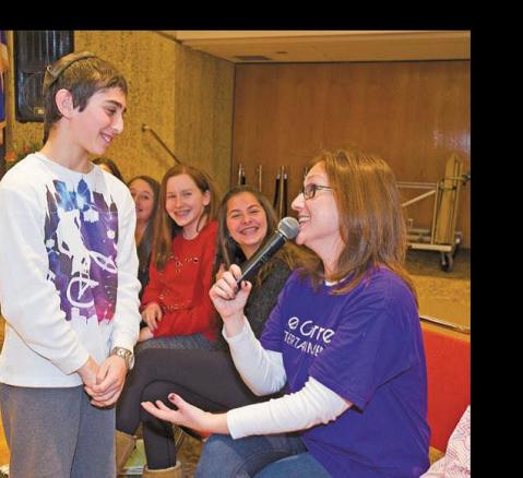 Matthew Berg, 11, of Farmington talks with Re-becca Schlussel of West Bloomfield about the proper way to say thank you after a bar mitzvah. 